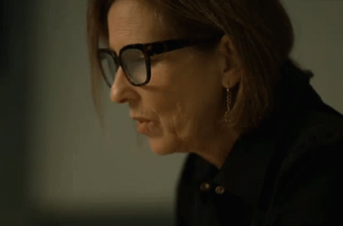 A Woman Wearing Glasses Is Drinking From A Can Of Soda GIF