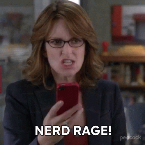 A Woman Wearing Glasses Is Holding A Cell Phone And Says Nerd Rage . GIF