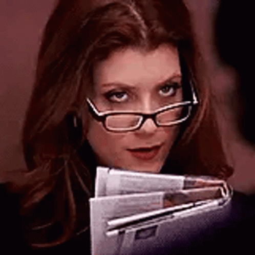 Woman Wearing Glasses Holding Newspapers GIF