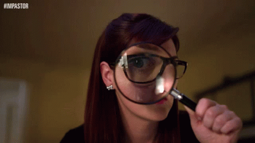 A Woman Wearing Glasses Is Looking Through A Magnifying Glass With The Hashtag #Impastor On The Bottom GIF