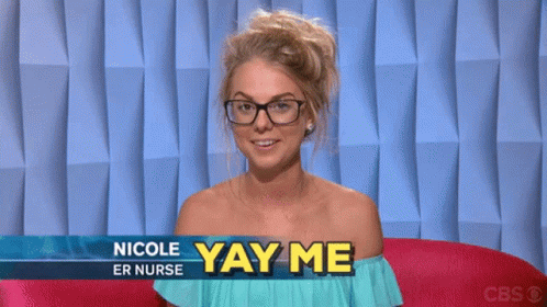 A Woman Wearing Glasses Is Sitting In Front Of A Sign That Says " Nicole Er Nurse Yay Me " GIF
