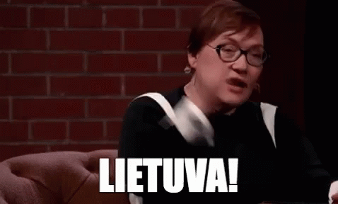 A Woman Wearing Glasses Is Sitting On A Couch With Her Hands In The Air And The Word Lietuva Written On Her Face . GIF