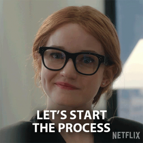 A Woman Wearing Glasses Is Smiling And Says Let 'S Start The Process GIF