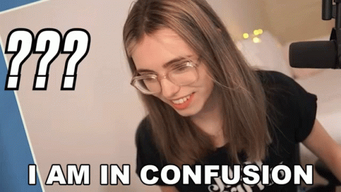 A Woman Wearing Glasses Is Smiling In Front Of A Microphone With The Words I Am In Confusion Below Her GIF