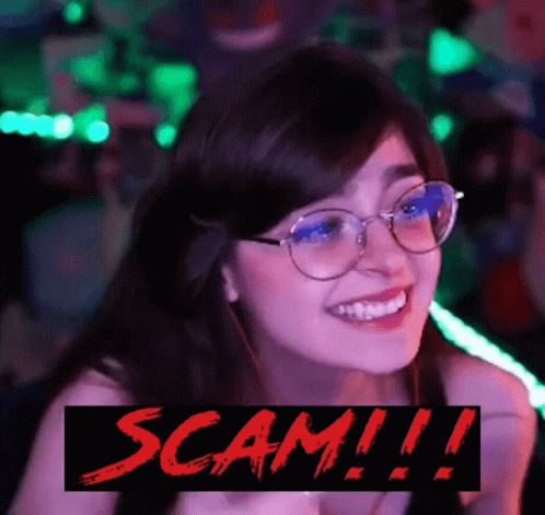 A Woman Wearing Glasses Is Smiling With The Words Scam !!! Below Her GIF