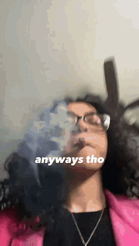 a woman wearing glasses is smoking a cigarette with the words anyways tho written on the bottom .
