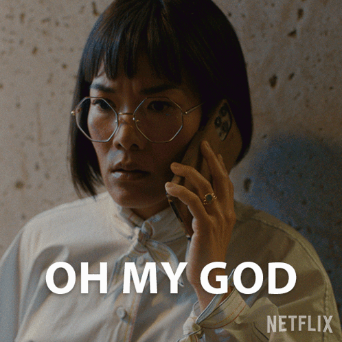 A Woman Wearing Glasses Is Talking On A Cell Phone With The Words Oh My God Written Below Her GIF