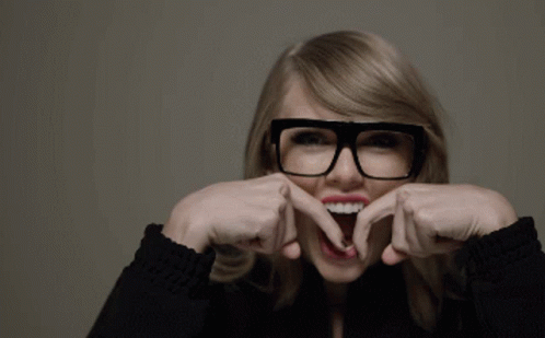 A Woman Wearing Glasses Making A Funny Face GIF