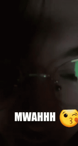 A Woman Wearing Glasses Says Mwahhh Next To A Kissing Smiley Face GIF