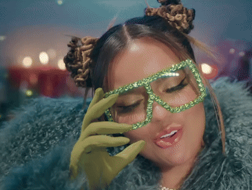 A Woman Wearing Green Gloves And Green Glasses Covering Her Face GIF