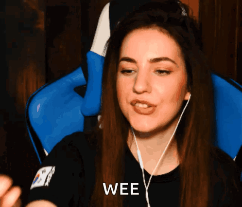 A Woman Wearing Headphones And A Black Shirt With The Word Wee On It GIF