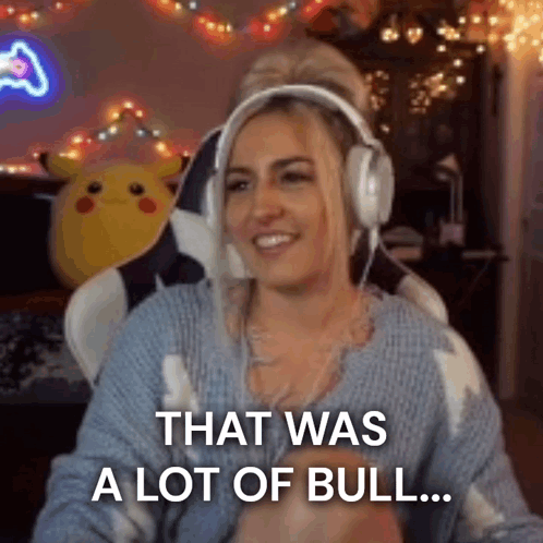 A Woman Wearing Headphones And A Blue Sweater Is Sitting In A Chair . GIF