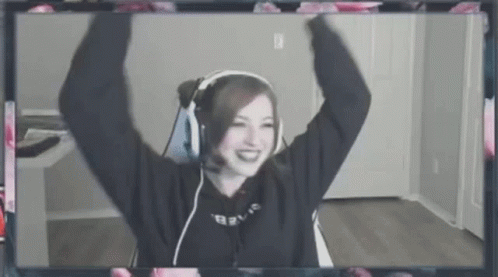 A Woman Wearing Headphones And A Microphone Is Sitting In Front Of A Computer Screen . GIF
