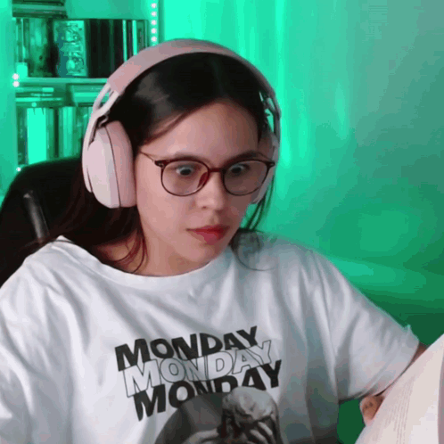 A Woman Wearing Headphones And A Monday Monday T-Shirt GIF