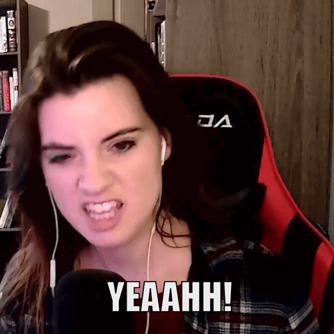 A Woman Wearing Headphones And A Red Gaming Chair Says Yeaahhh GIF