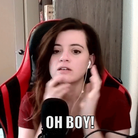 A Woman Wearing Headphones And A Red Shirt Is Sitting In Front Of A Microphone . GIF