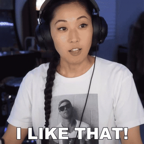 A Woman Wearing Headphones And A Shirt That Says " I Like That " GIF