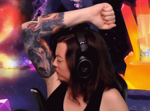 A Woman Wearing Headphones And A Tattoo On Her Arm GIF