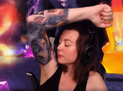 A Woman Wearing Headphones And A Tattoo On Her Arm GIF