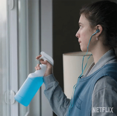A Woman Wearing Headphones And A Vest That Says Netflix GIF