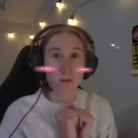 a woman wearing headphones and a white shirt is smiling