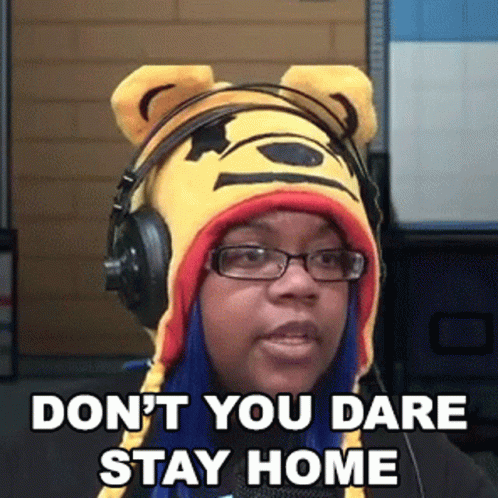 A Woman Wearing Headphones And A Winnie The Pooh Hat Says " Don T You Dare Stay Home " GIF