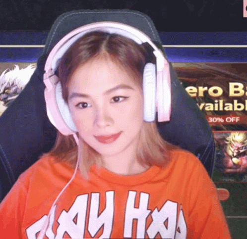 A Woman Wearing Headphones And An Orange Shirt That Says ' My Ho ' GIF