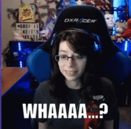 A Woman Wearing Headphones And Glasses Is Sitting In A Gaming Chair With The Words Whaaa Written On The Bottom GIF