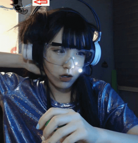 A Woman Wearing Headphones And Goggles Has An Arrow Pointing Up GIF