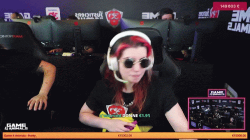 A Woman Wearing Headphones And Sunglasses Is Sitting In Front Of A Computer Screen That Says Game 4 Animals GIF