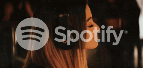 A Woman Wearing Headphones And The Spotify Logo GIF