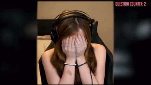 A Woman Wearing Headphones Covering Her Face With Her Hands In Front Of A Question Counter That Reads Question Counter 2 GIF