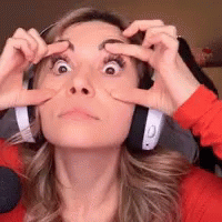 A Woman Wearing Headphones Has Her Hands On Her Eyes GIF