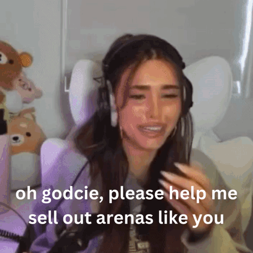 A Woman Wearing Headphones Is Crying And Asking For Help To Sell Out Arenas Like You GIF