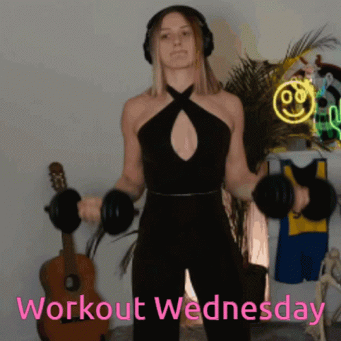 a woman wearing headphones is lifting dumbbells and the words workout wednesday are visible behind her