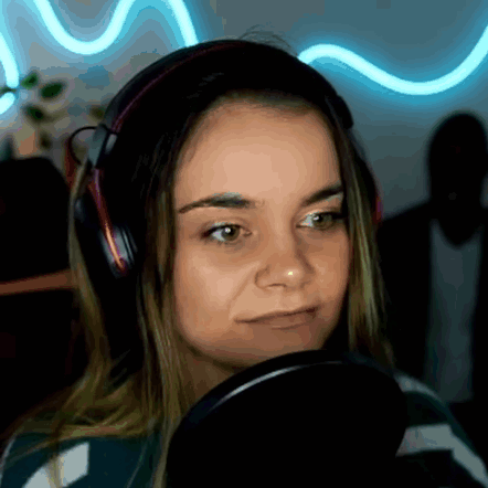 A Woman Wearing Headphones Is Looking At A Microphone . GIF