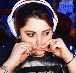 a woman wearing headphones is making a face