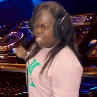 A Woman Wearing Headphones Is Making A Funny Face In Front Of A Dj GIF