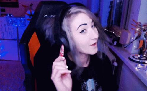 A Woman Wearing Headphones Is Sitting In A Chair That Says Quef On It GIF