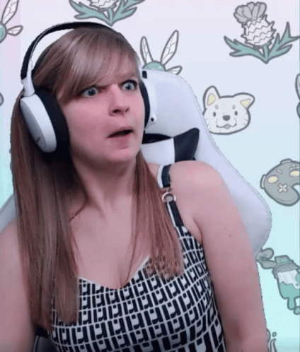 A Woman Wearing Headphones Is Sitting In A White Chair GIF