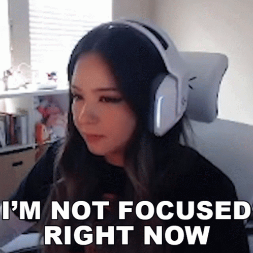 A Woman Wearing Headphones Is Sitting In Front Of A Computer . GIF