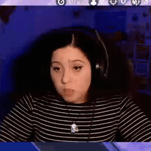 A Woman Wearing Headphones Is Sitting In Front Of A Computer Screen With The Words Ok Cool Written On It . GIF