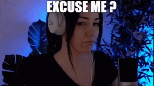 A Woman Wearing Headphones Is Sitting In Front Of A Microphone And Says `` Excuse Me ? '' GIF