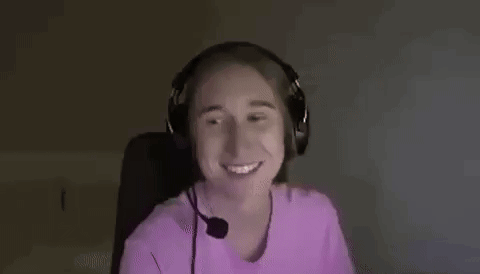 a woman wearing headphones is smiling and making a funny face .