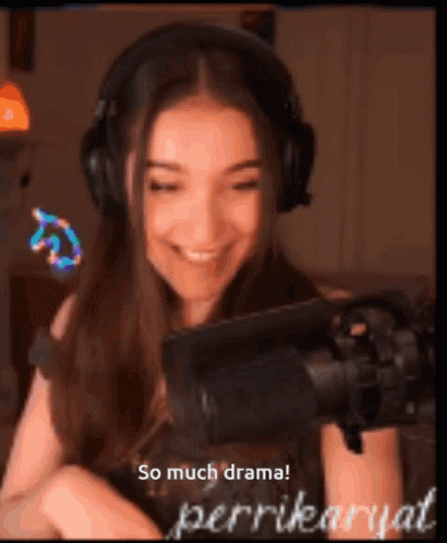 A Woman Wearing Headphones Is Smiling In Front Of A Microphone With The Words So Much Drama Written Below Her GIF