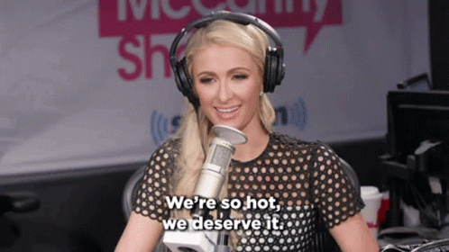 A Woman Wearing Headphones Is Talking Into A Microphone And Says " We 'Re So Hot We Deserve It " GIF