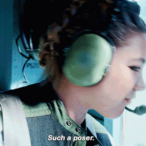 A Woman Wearing Headphones Says Such A Poser In A Close Up GIF