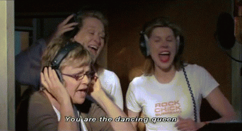 A Woman Wearing Headphones Says " You Are The Dancing Queen " While Another Woman Laughs GIF