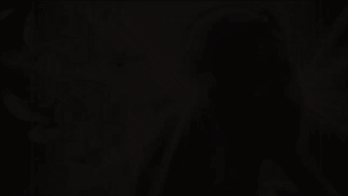 A Woman Wearing Headphones With Birds Flying Around Her GIF