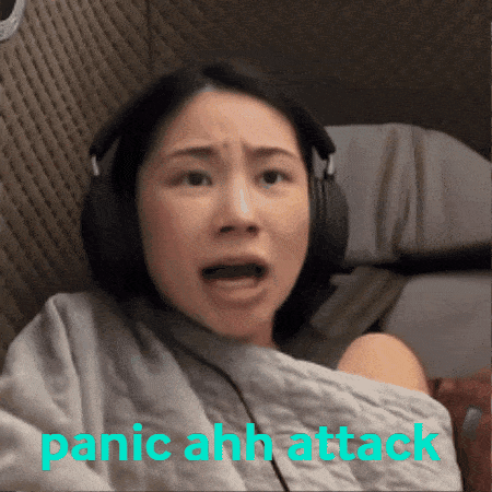 A Woman Wearing Headphones With The Words Panic Ahh Attack Written Below Her GIF